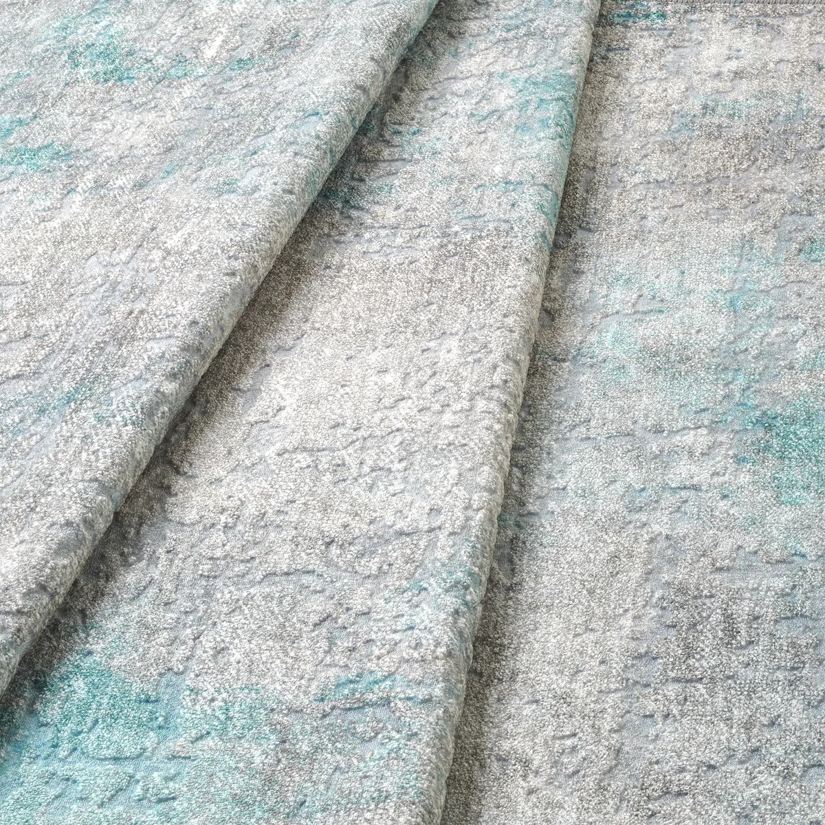 Dettaglio onda del tappeto Onis Turch bouclé 3D con rilievo morbido nei toni sabbia e azzurro.