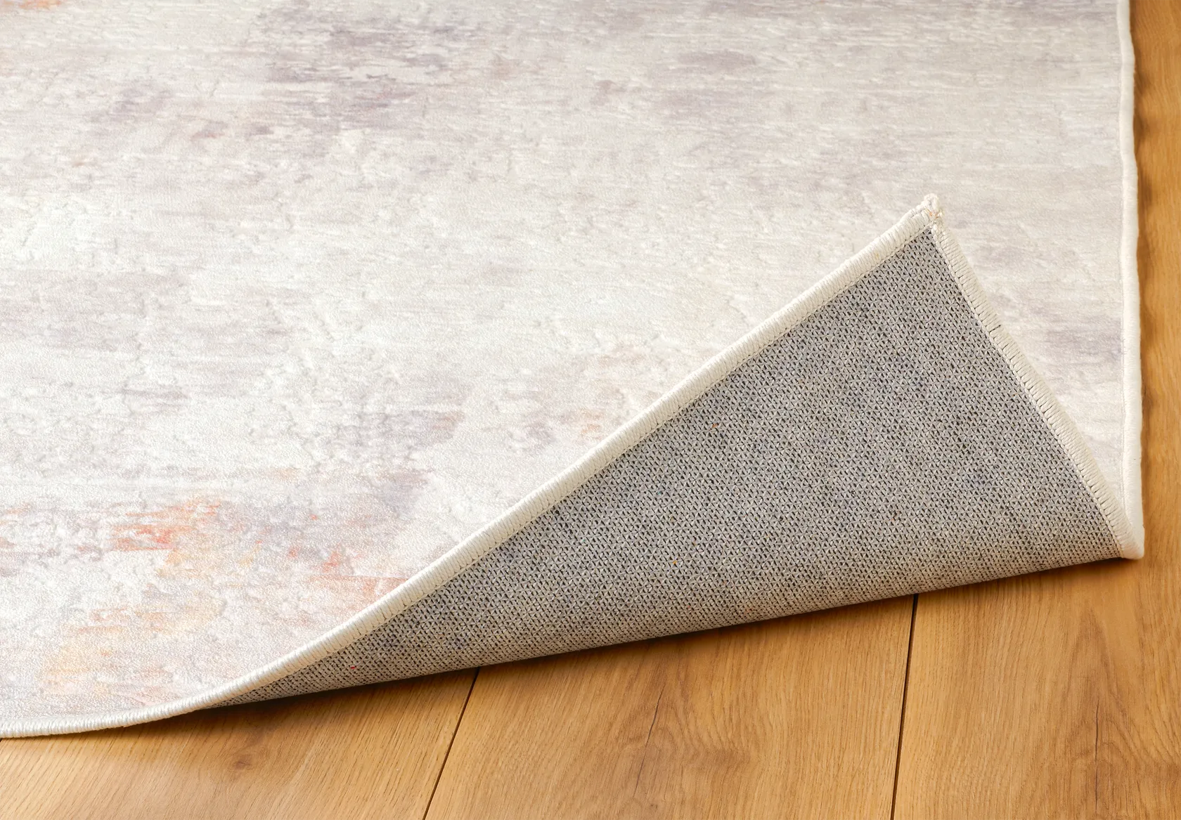 Angolo del tappeto Jorg Rust bouclé 3D con bordo rifinito e retro antiscivolo.