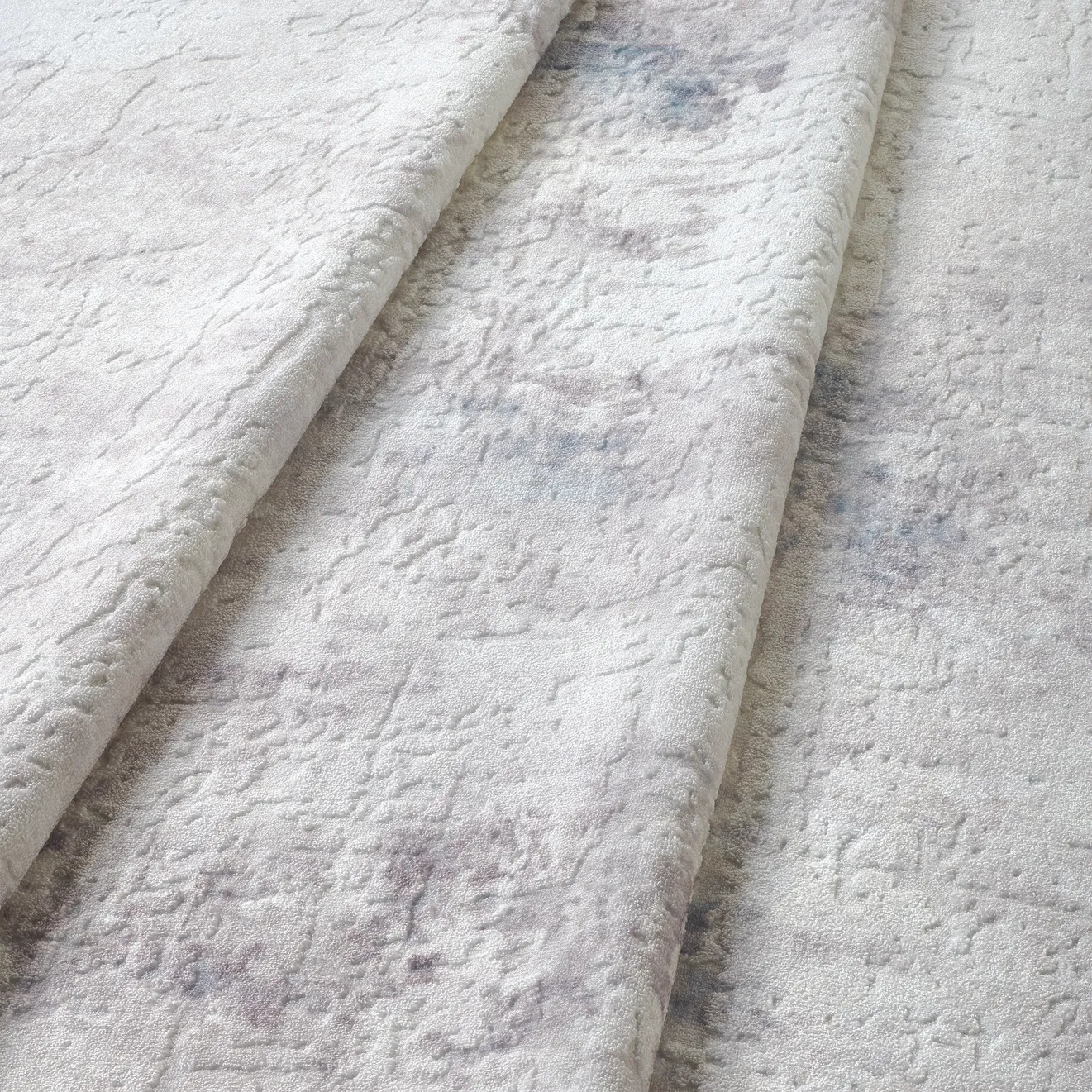 Dettaglio onda del tappeto Jorg PastBlue bouclé 3D con rilievo azzurro e grigio.