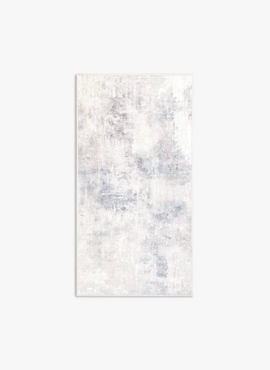 Tappeto Jorg PastBlue bouclé 3D 80×150 cm con sfumature azzurro polvere e sabbia visto dall’alto.