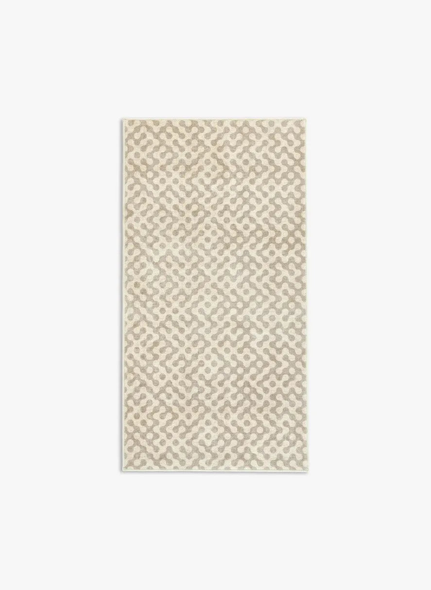 Tappeto Haral 80×150 cm in pelo taftato, toni neutri beige e grigio caldo, visto dall’alto.