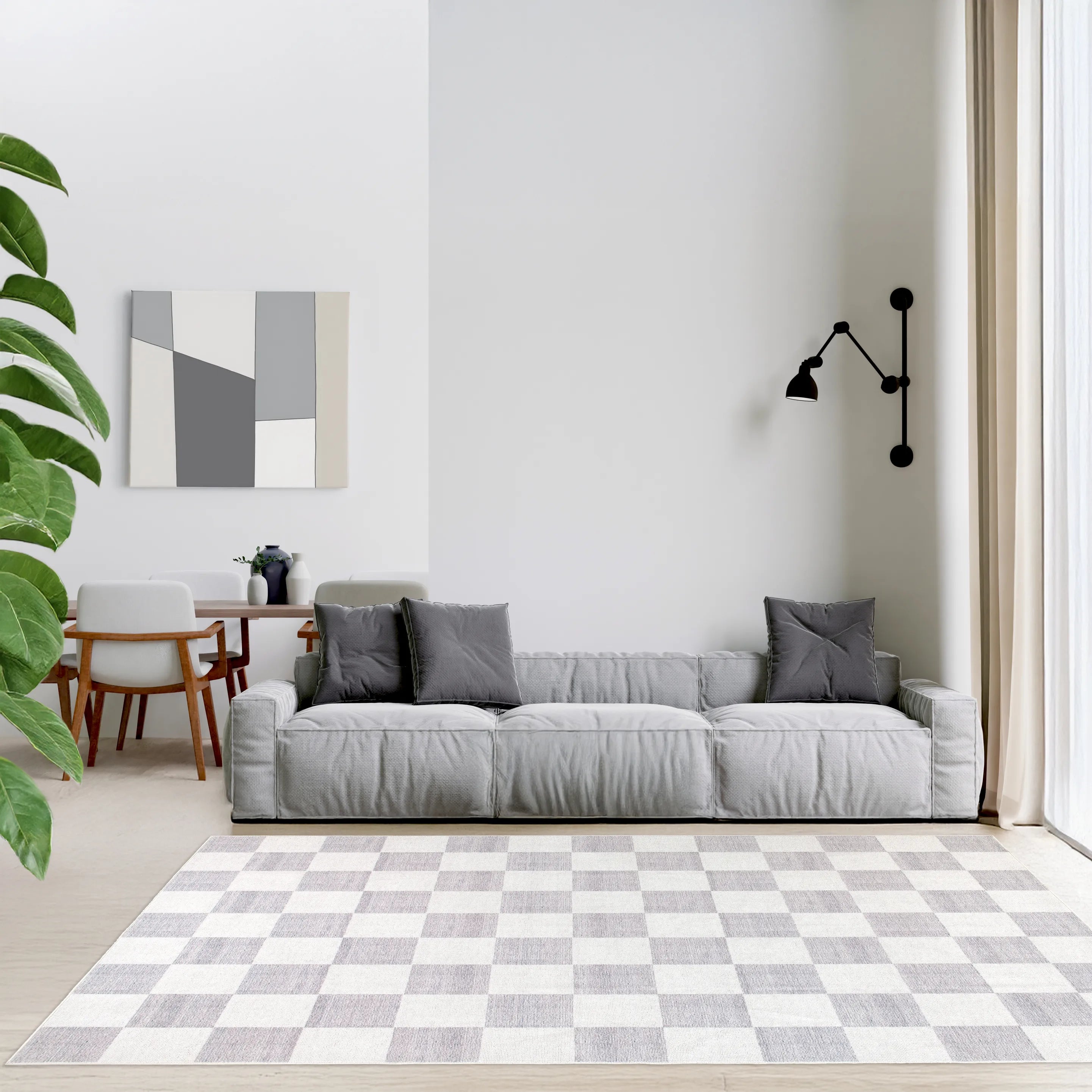 Tappeto Jack LtGrey 200×290 cm davanti a divano modulare grigio in soggiorno moderno, tavolo da pranzo sullo sfondo e pareti chiare.