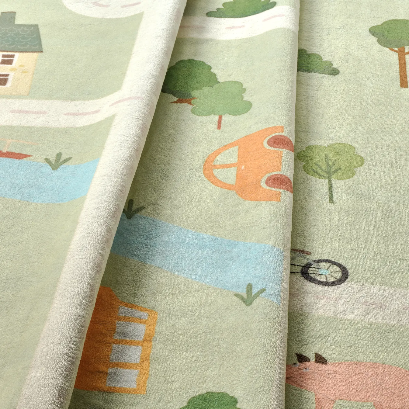 Dettaglio onda del tappeto Ecovia in pelo corto di microfibra, superficie morbida con stampa di strade, casette e prato verde.