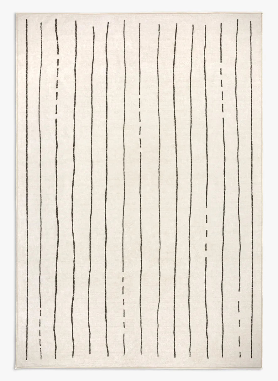 Tappeto Lead 160×230 cm crema con righe nere stile tuareg; lavabile in lavatrice a 40° e asciugabile in asciugatrice, antimacchia e impermeabile.